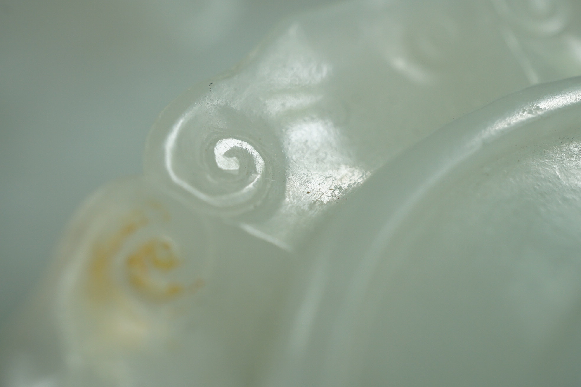 A Chinese white and russet jade petal lobed cup stand